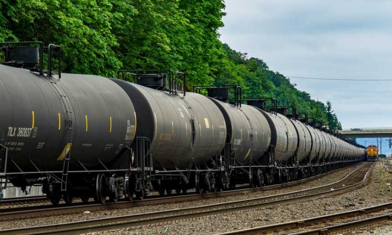 black oil trains lined up on tracks